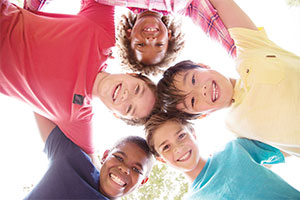 A group of smiling children standing in a circle