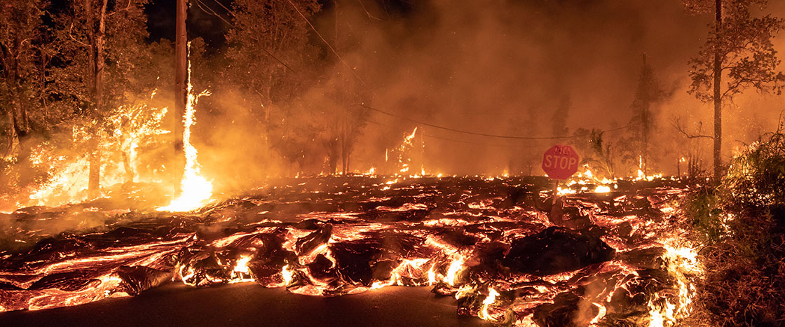 Trees on fire as lava moved through the area and smoke rises into the air