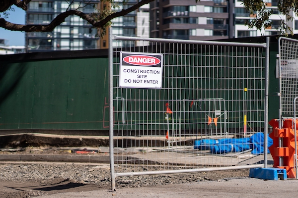 A fence with a sign stating "danger"