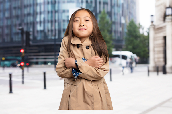 A girl wearing a winter coat with her arms crossed stubbornly