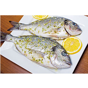 Two fish and slices of lemon on a plate